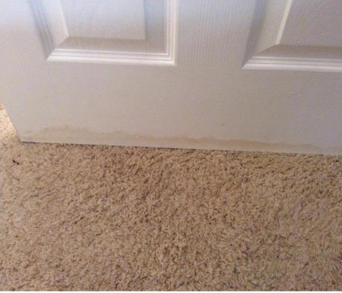 water damaged door and carpet