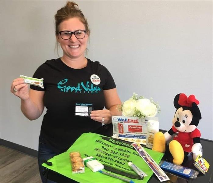 Female holding snacks with Minnie Mouse toy on table