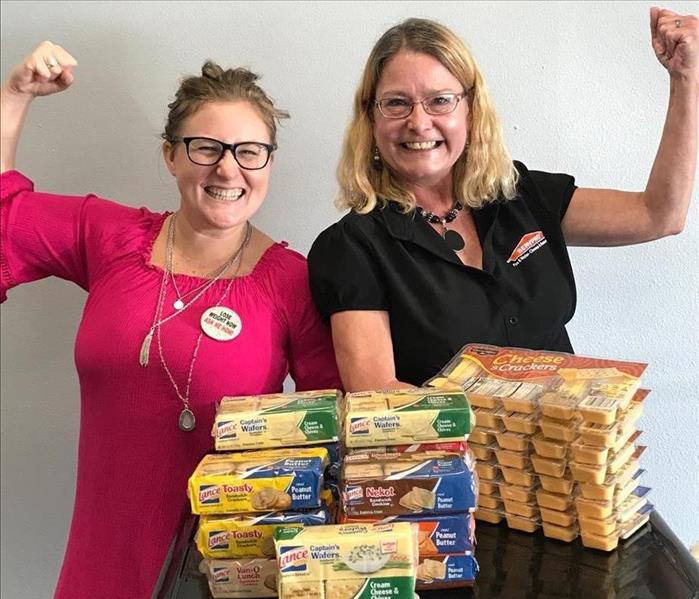 lady in pink shirt, lady in black shirt, snack food