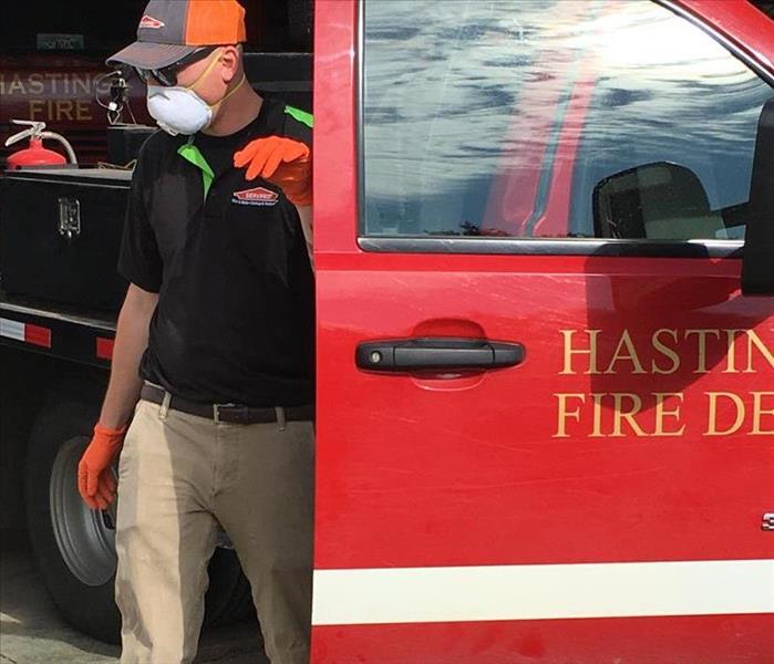 Red fire truck, man in black shirt