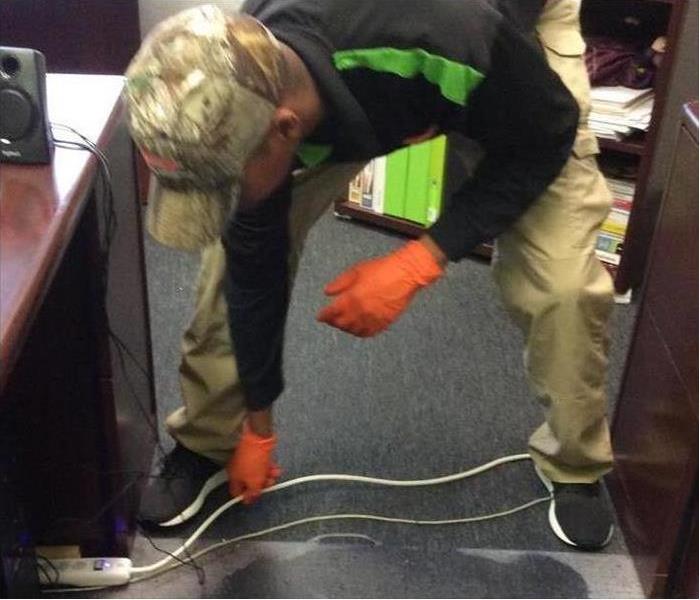 desk, power cords, man in black shirt