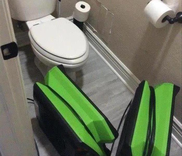 bathroom toilet, wet floor, green equipmemnt