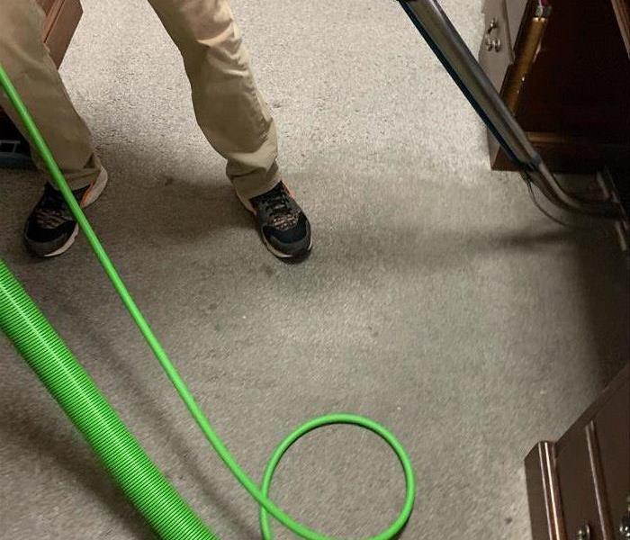 man in tan pants cleaning carpet