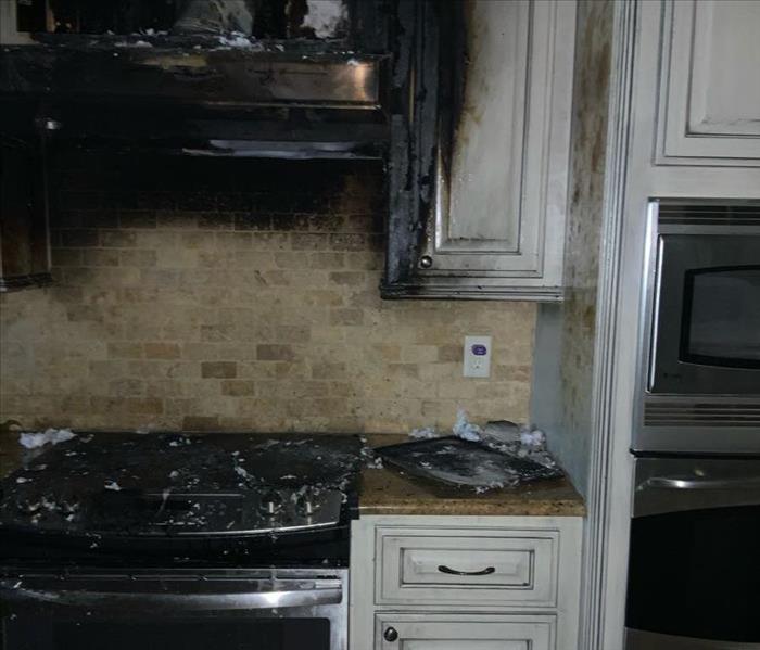 Fire burned stove and cabinet