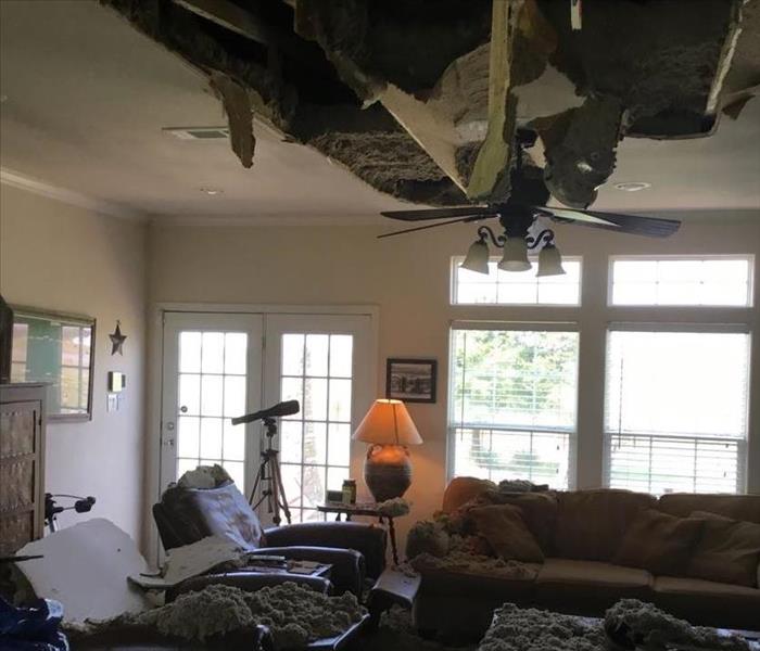 living room with ceiling falling in