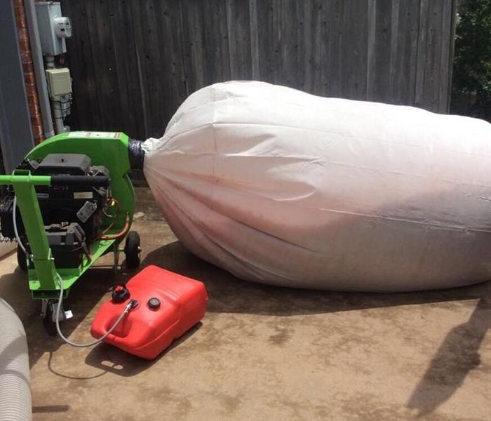 large vacuum bag in driveway