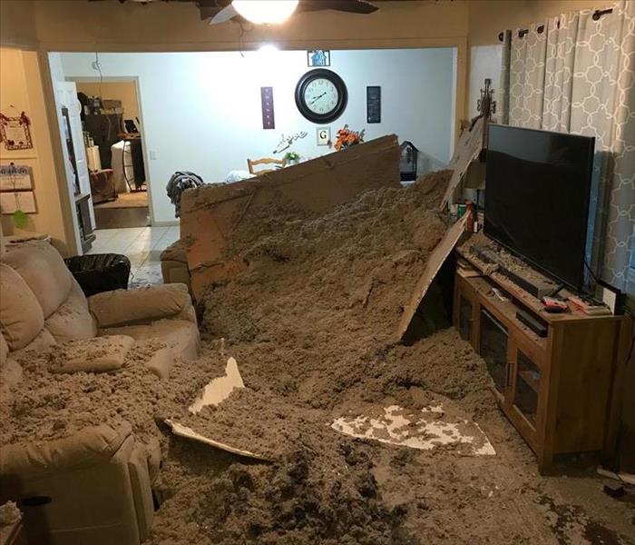 living room with fallen ceiling debris