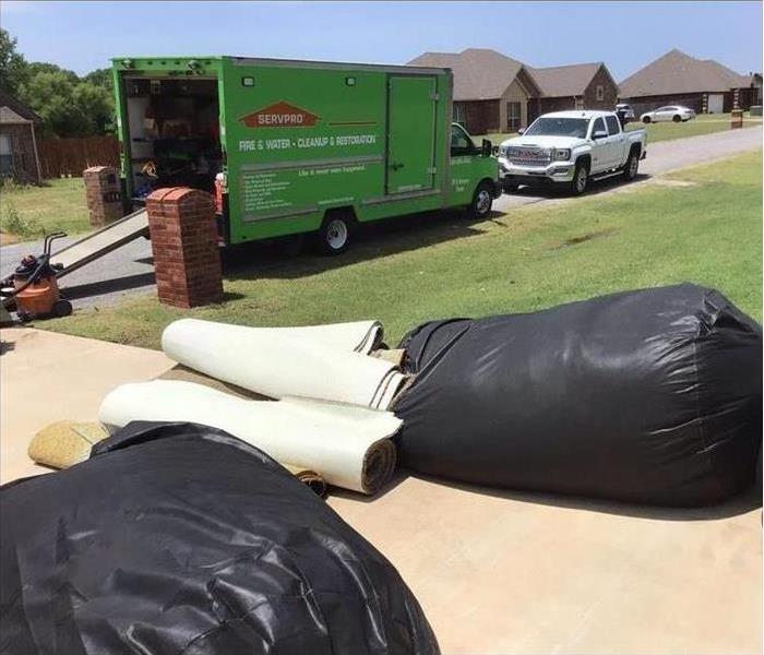 driveway, large trash bags, green truck