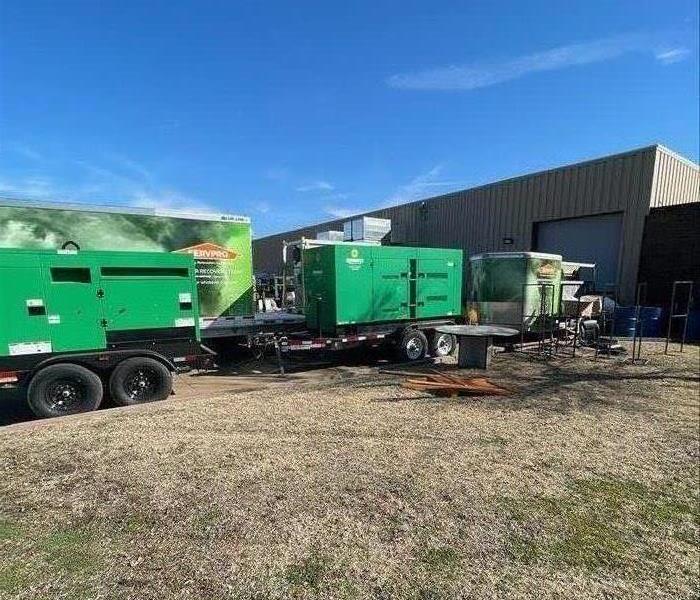 large green equipment and SERVPRO trailers 