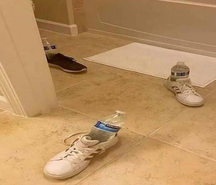 shoes with water bottles in bathroom