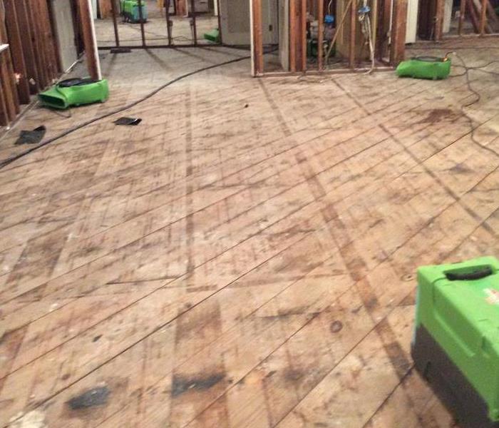 bare wood floors, bare wall studs, green equipment
