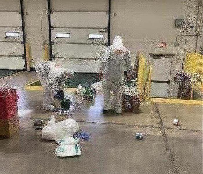 two men in white PPE
