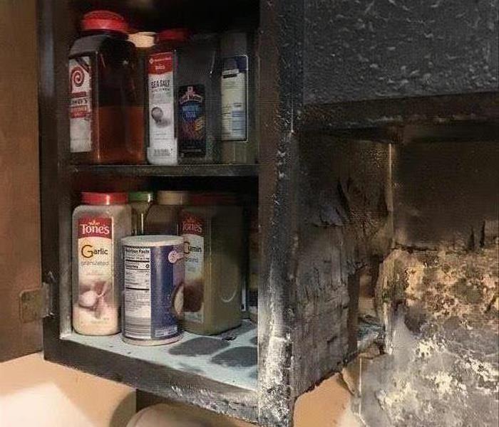 burned kitchen cabinet, jars of charred spices