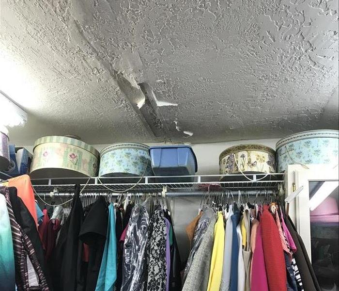 wet closet ceiling and clothes